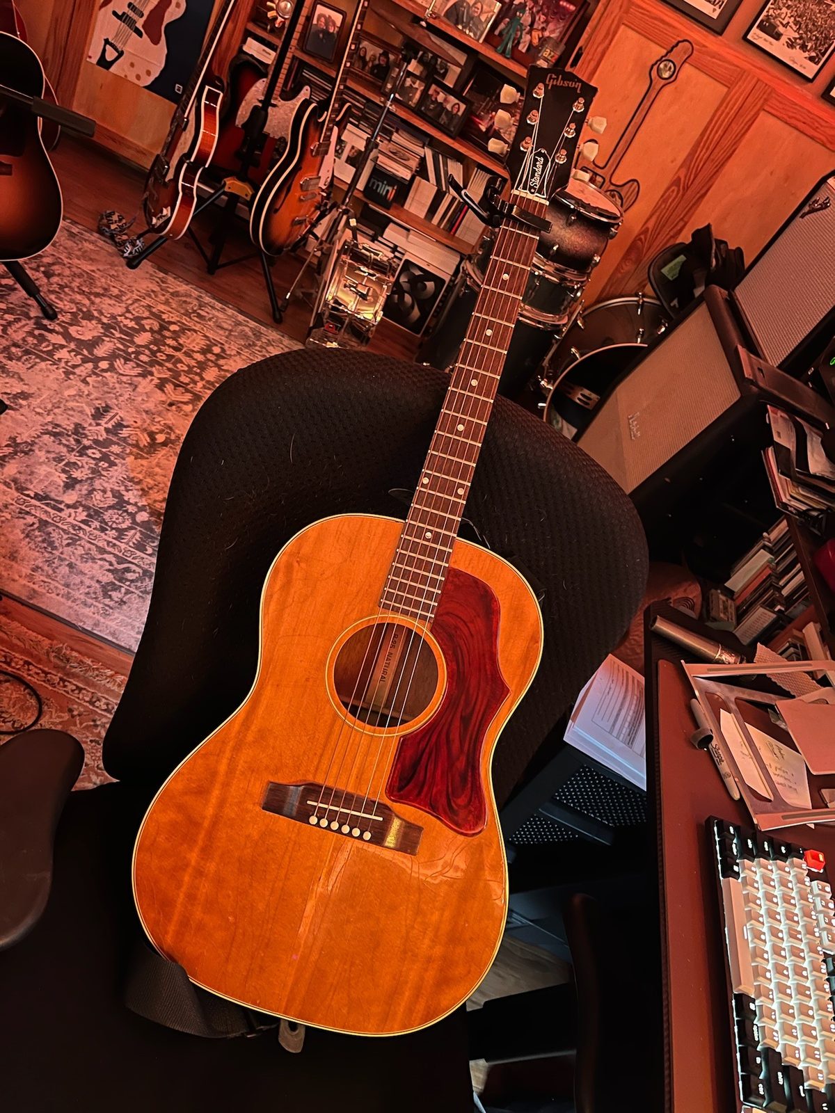 An acoustic guitar on the studio chair, March 2024